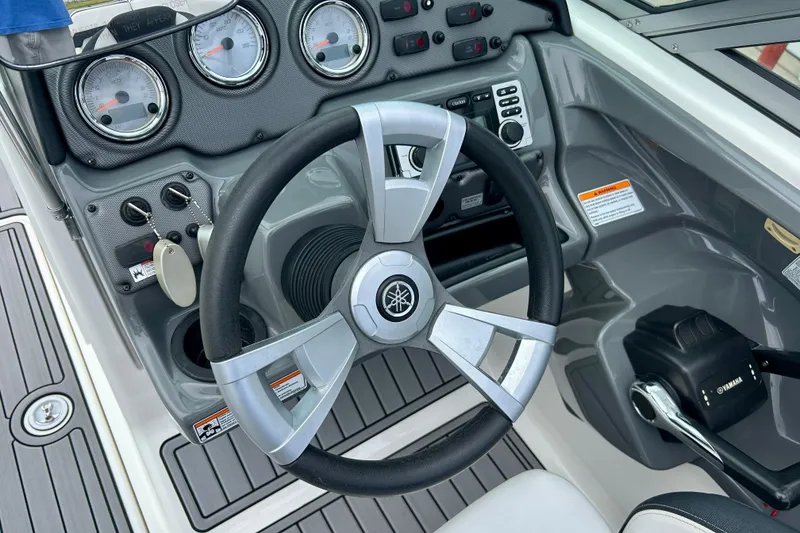 Slide: The Image of Steering wheel and dashboard of 2015 Yamaha AR210 boat cockpit. - 26