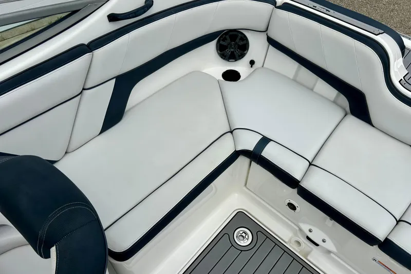 Slide: The Image of 2015 Yamaha Boats AR210 interior seating with white and navy upholstery. - 35