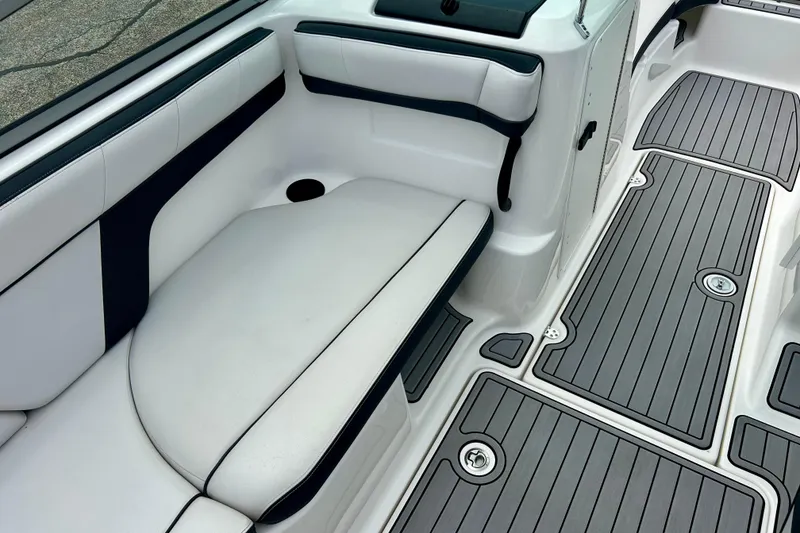 Slide: The Image of 2015 Yamaha AR210 boat interior with cushioned seating and sleek flooring design. - 36