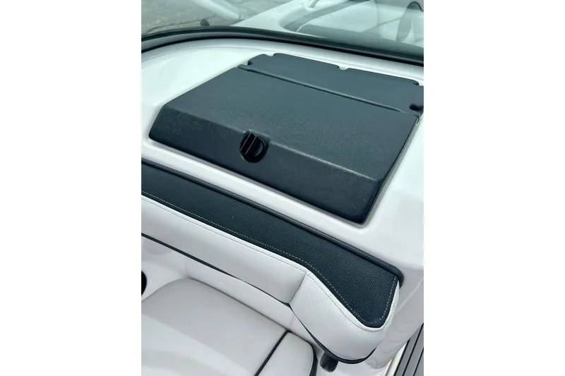 Slide: The Image of 2015 Yamaha AR210 boat dashboard with black cover and white seating detail. - 37
