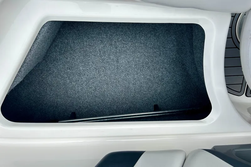 Slide: The Image of Storage compartment in 2015 Yamaha AR210 boat, featuring a spacious, carpeted interior. - 40