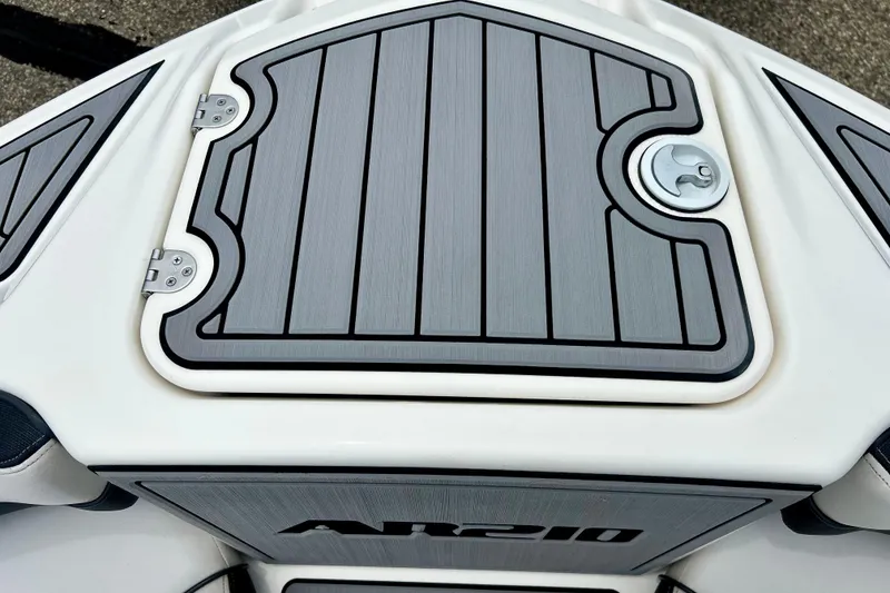 Slide: The Image of 2015 Yamaha Boats AR210 deck with sleek gray paneling and secure latch. - 49