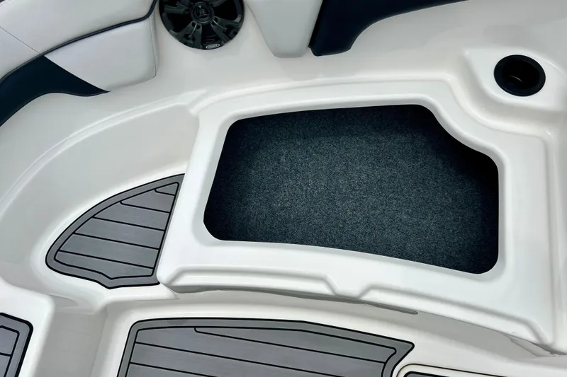 Slide: The Image of Interior view of a 2015 Yamaha AR210 boat, featuring storage compartment and speaker. - 52
