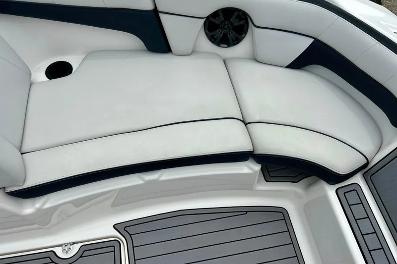 Slide: The Image of 2015 Yamaha AR210 boat interior with cushioned seating and speaker detail. - 53