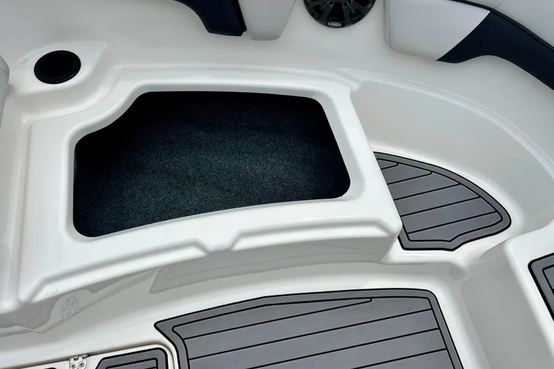Slide: The Image of 2015 Yamaha AR210 boat interior storage compartment with sleek design and non-slip flooring. - 54