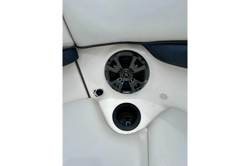 Slide: The Image of Speaker and cup holder on 2015 Yamaha AR210 boat interior. - 58