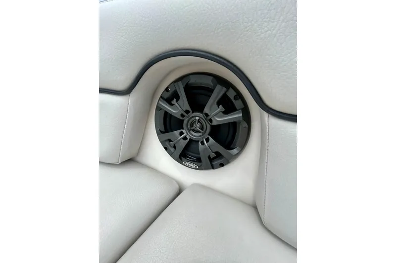 Slide: The Image of Speaker system on 2015 Yamaha Boats AR210, integrated into white cushioned seating. - 59