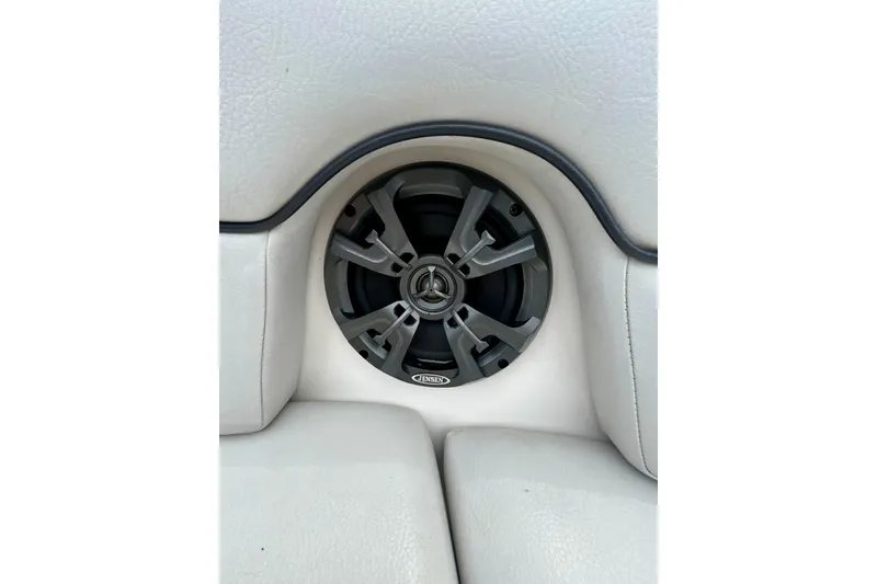 Slide: The Image of Speaker system in 2015 Yamaha Boats AR210, integrated into white cushioned seating. - 60