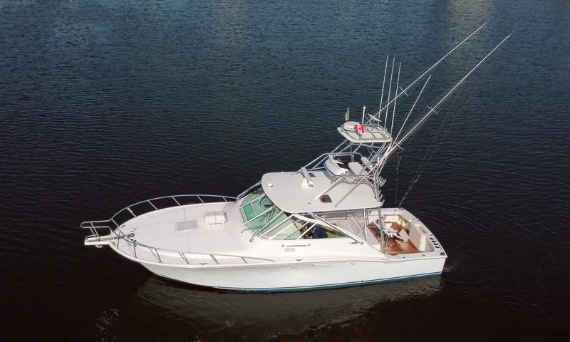 Slide: The Image of 2005 Cabo 40 Express boat on calm water. - 4