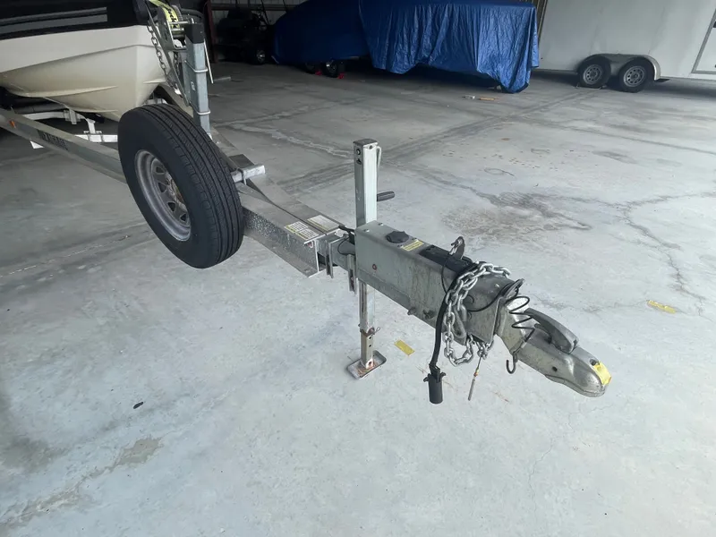 Slide: The Image of Boat trailer with chain and spare tire in garage. - 4