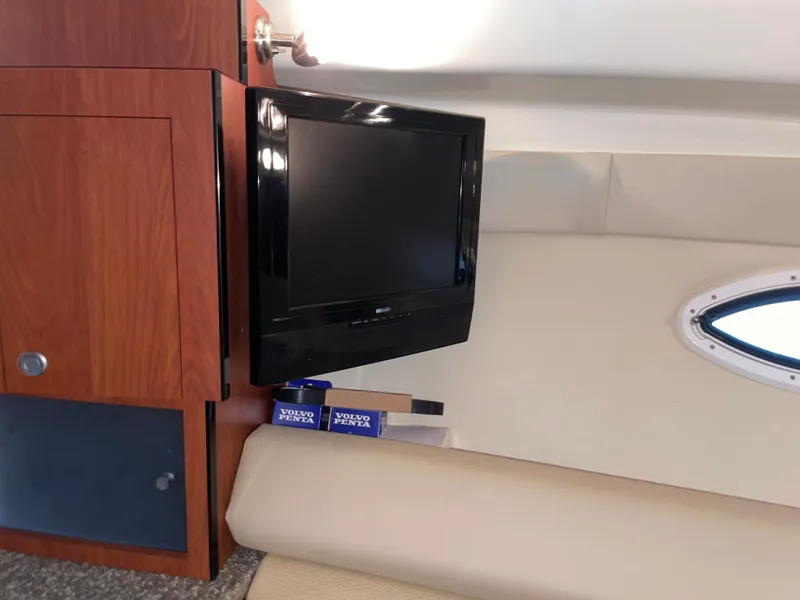Slide: The Image of Interior of a Monterey 280 Sport Cruiser with TV and wooden cabinet. - 37