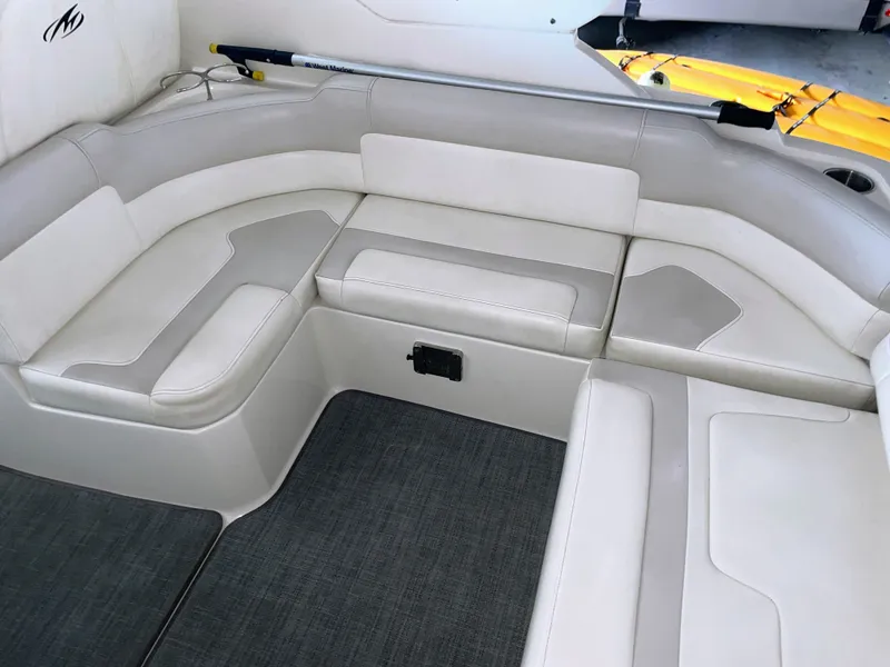 Slide: The Image of Interior of a 2010 Monterey 280 Sport Cruiser with white seating. - 21