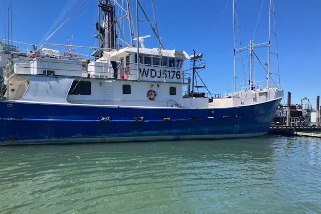 Slide: The Image of Custom 1995 Steel Albacore Tuna Vessel docked in calm waters. - 16