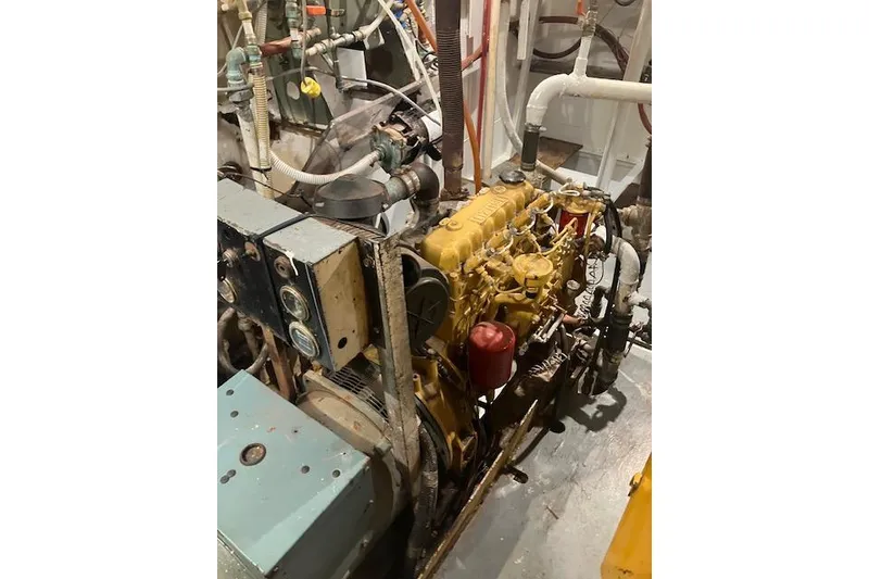 Slide: The Image of Engine room of a 1995 Custom Steel Albacore Tuna Vessel, showcasing machinery and pipes. - 19