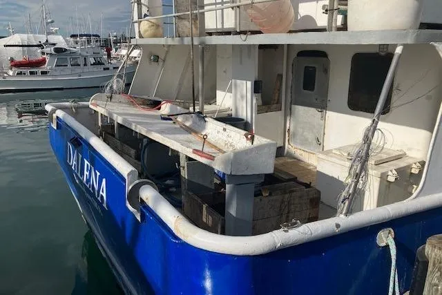 Slide: The Image of Custom 1995 Steel Albacore Tuna Vessel docked at marina, featuring blue hull and fishing equipment. - 3