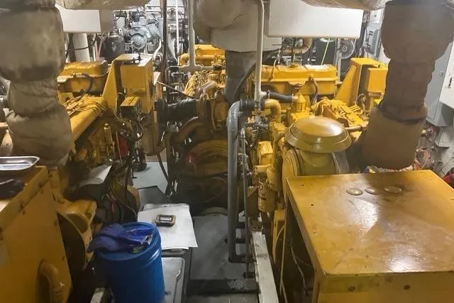 Slide: The Image of Engine room of a 1995 Custom Steel Albacore Tuna Vessel with yellow machinery. - 6