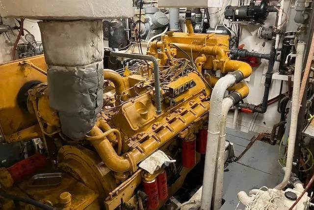 Slide: The Image of Engine room of a 1995 Custom Steel Albacore Tuna Vessel, showcasing machinery and pipes. - 7