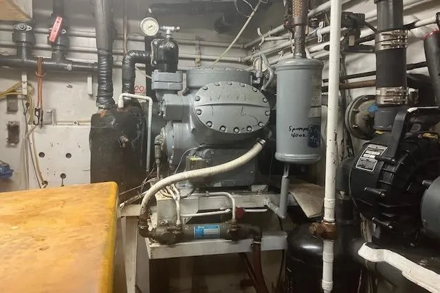 Slide: The Image of Engine room of a 1995 Custom Steel Albacore Tuna Vessel, showcasing machinery and pipes. - 9