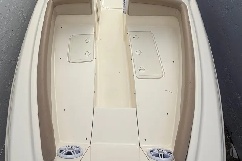 Slide: The Image of 2023 Scout 210 Dorado boat interior with beige seating and storage compartments. - 10