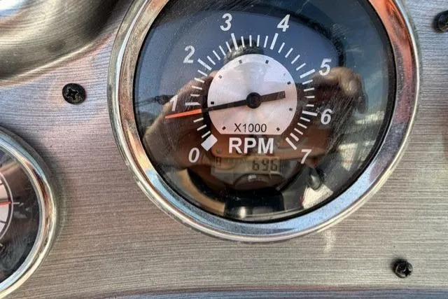 Slide: The Image of Close-up of a 2023 NauticStar 223 DC tachometer showing RPM gauge. - 13