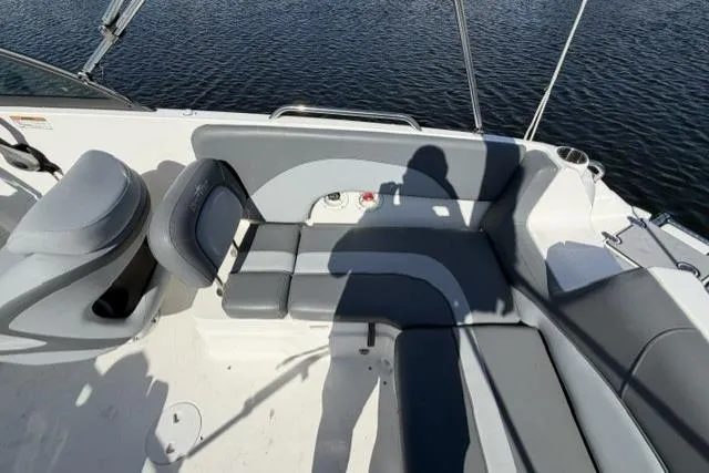 Slide: The Image of 2023 NauticStar 223 DC boat interior with gray seating and water view. - 22