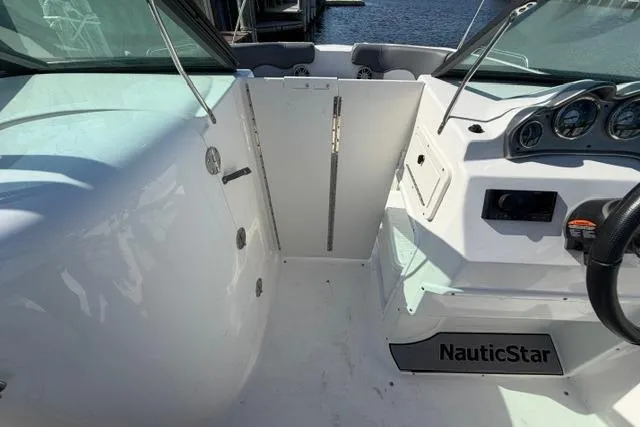 Slide: The Image of 2023 NauticStar 223 DC boat interior with steering wheel and dashboard. - 25