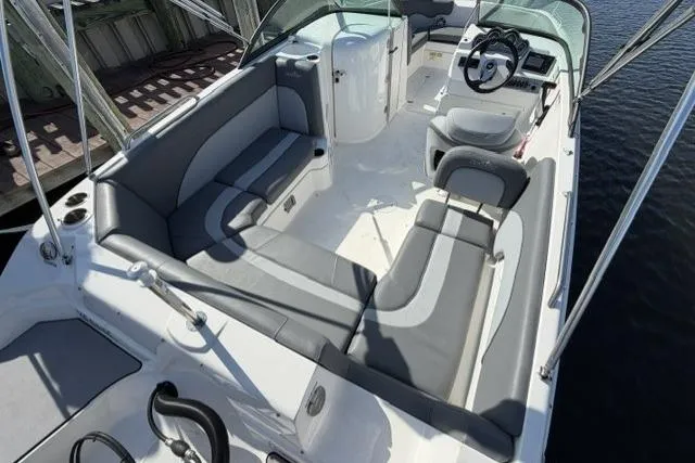 Slide: The Image of 2023 NauticStar 223 DC boat interior with sleek seating and modern dashboard. - 26
