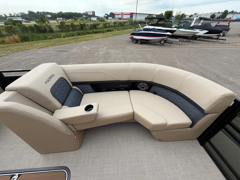 Slide: The Image of The image shows the beige and gray seating area of a 2027 Harris 230SOL boat. - 43