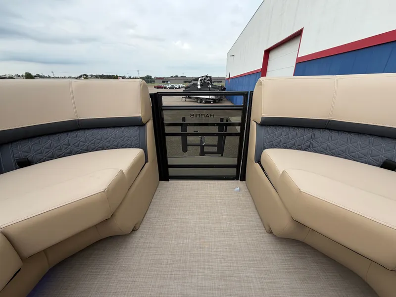 Slide: The Image of The image shows the interior of a 2027 Harris 230SOL with beige and gray seating. - 48