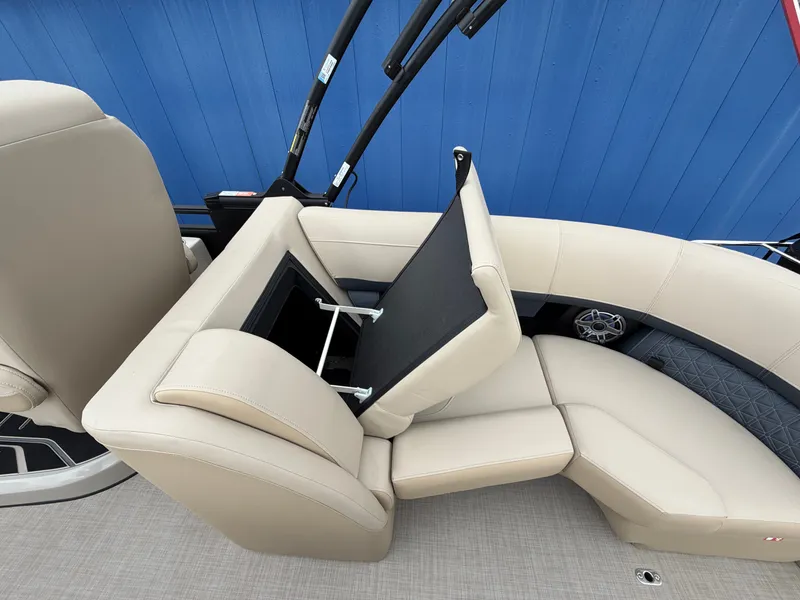 Slide: The Image of The image shows beige leather seating on a Harris 230SOL boat with an open storage compartment. - 16