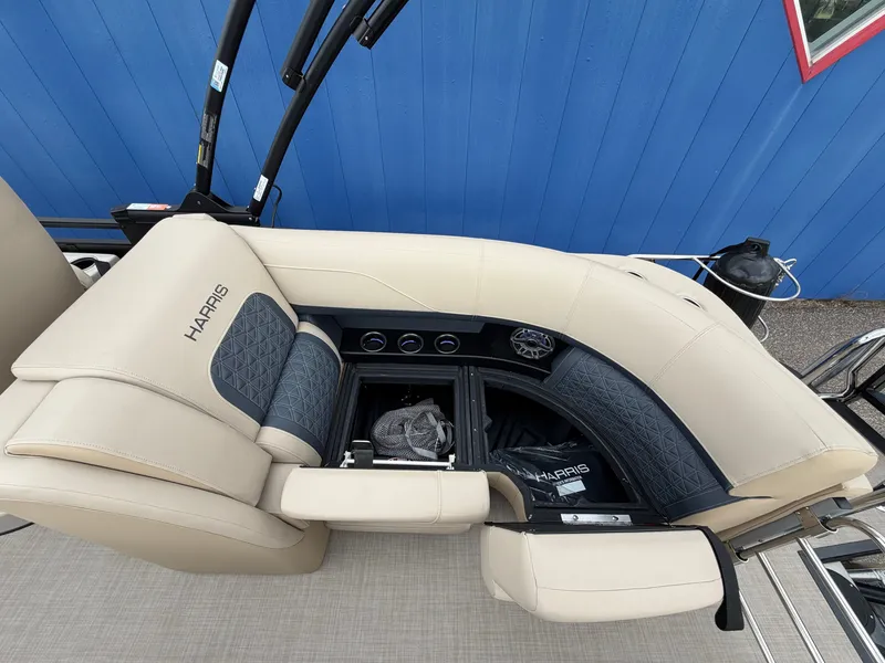 Slide: The Image of The image shows a luxurious bench seat on a Harris 230SOL boat, with beige and blue upholstery. - 15