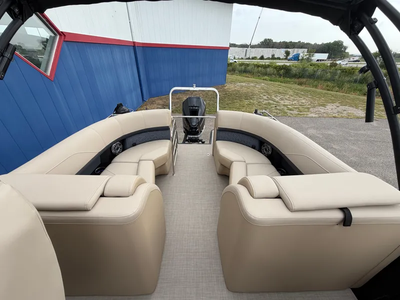 Slide: The Image of The image shows the interior of a Harris 230SOL pontoon boat with beige seating and an outboard motor. - 25