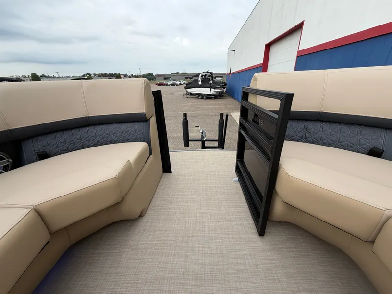 Slide: The Image of The image shows the interior of a 2027 Harris 230SOL with beige seating and an open stern. - 49