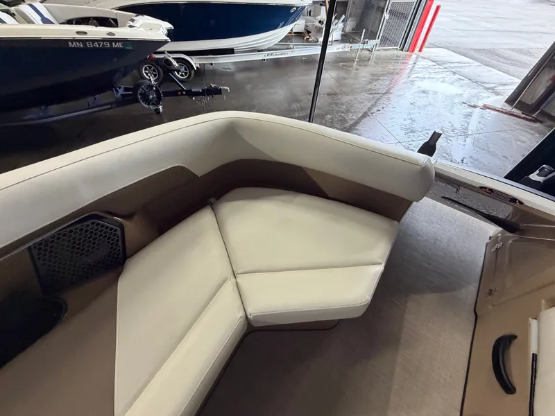 Slide: The Image of The 2027 Harris 250CRW features a sleek, cushioned seating area in a modern boat interior. - 27