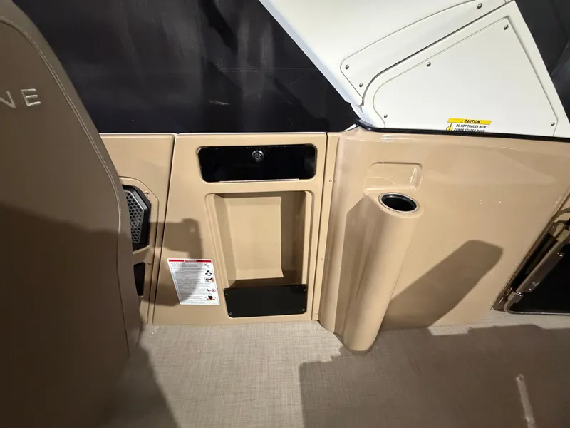 Slide: The Image of Interior of a 2027 Harris 250CRW with beige paneling and a cup holder. - 49