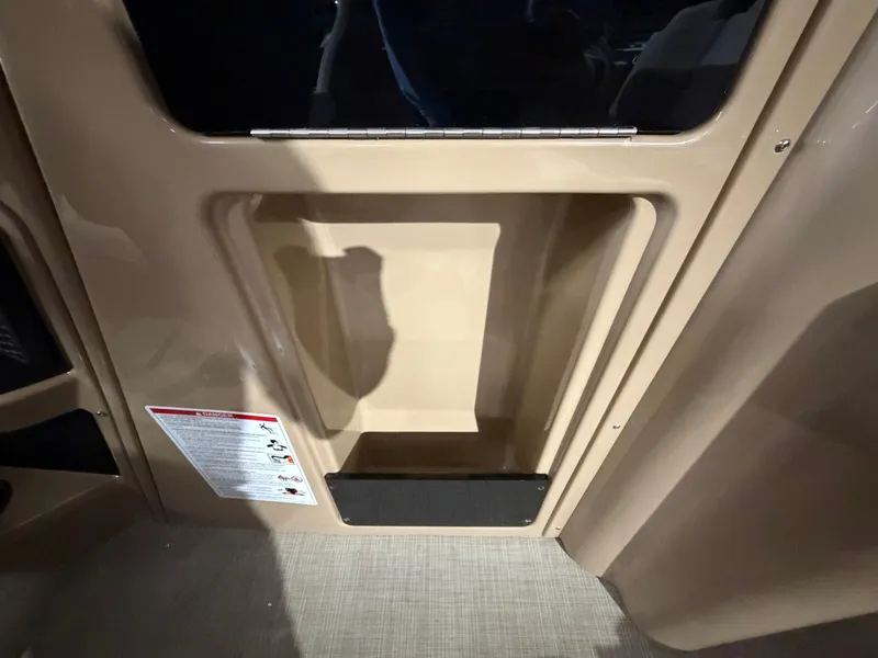 Slide: The Image of Interior of a 2027 Harris 250CRW with storage compartment and safety instructions. - 48
