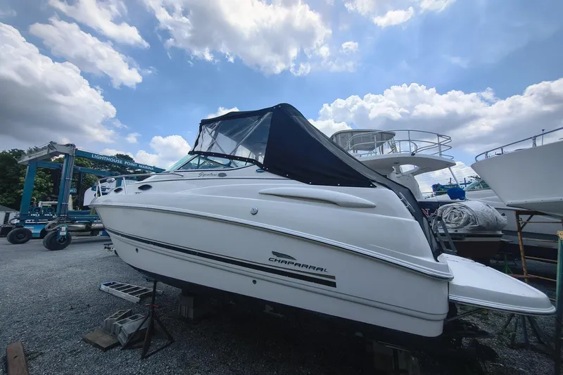 The Image of 2004 Chaparral Signature 240 boat at Lighthouse Point Marina under a cloudy sky. - 1