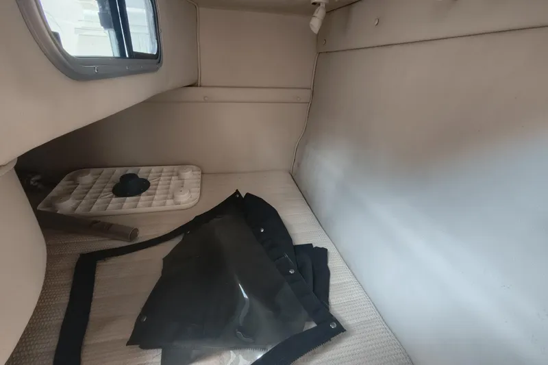 Slide: The Image of 2004 Chaparral Signature 240 cabin interior with window and folded cover. - 12
