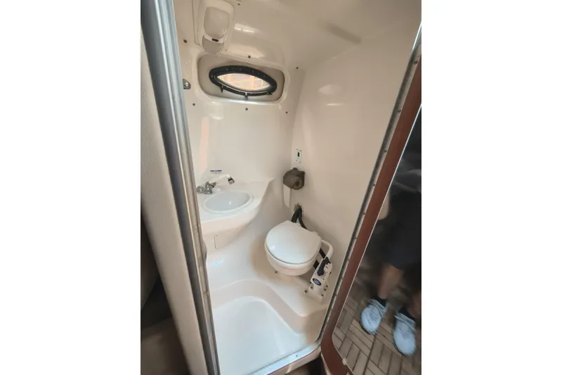 Slide: The Image of 2004 Chaparral Signature 240 boat bathroom with compact toilet and sink. - 13