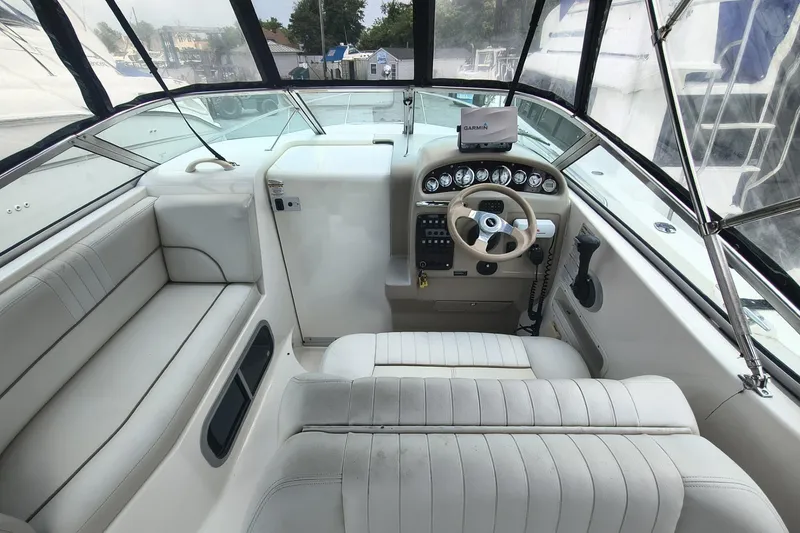 Slide: The Image of 2004 Chaparral Signature 240 boat interior with steering wheel and seating area. - 4