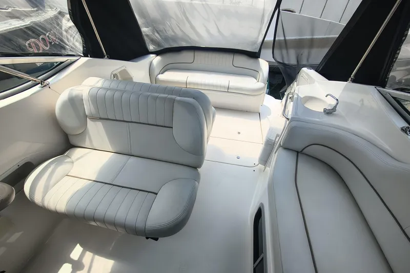 Slide: The Image of 2004 Chaparral Signature 240 boat interior with white seating and sleek design. - 5