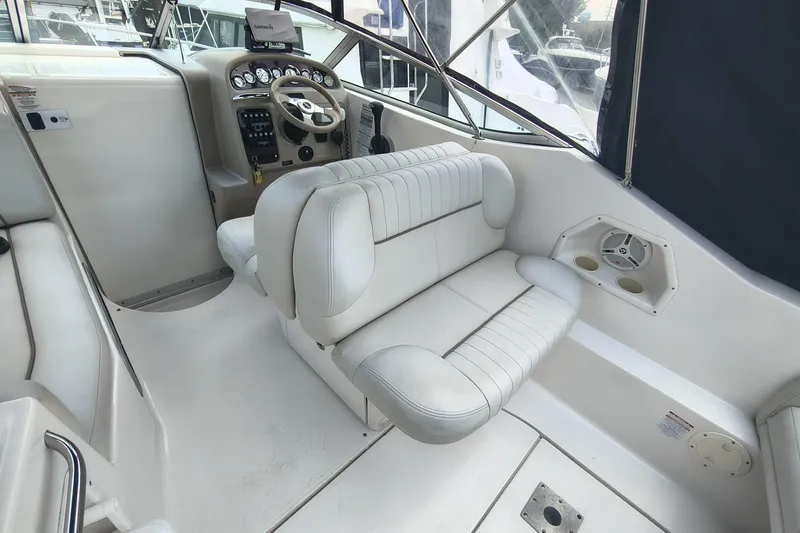 Slide: The Image of 2004 Chaparral Signature 240 boat interior with white seating and control panel. - 6