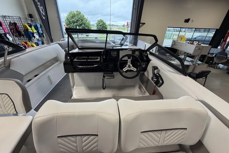 Slide: The Image of 2024 Glastron GTD 240 boat interior with modern dashboard and seating. - 18