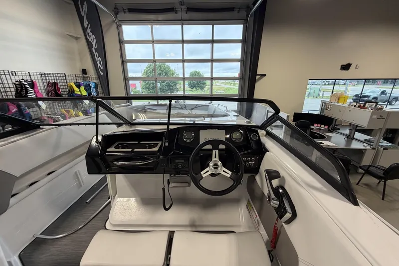 Slide: The Image of 2024 Glastron GTD 240 boat interior with modern dashboard and steering wheel. - 19