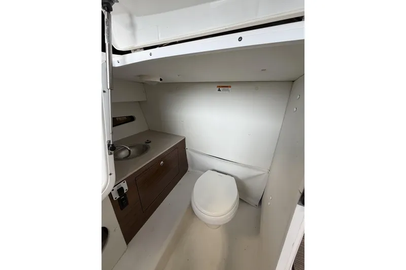 Slide: The Image of 2024 Glastron GTD 240 boat interior bathroom with sink and toilet. - 27