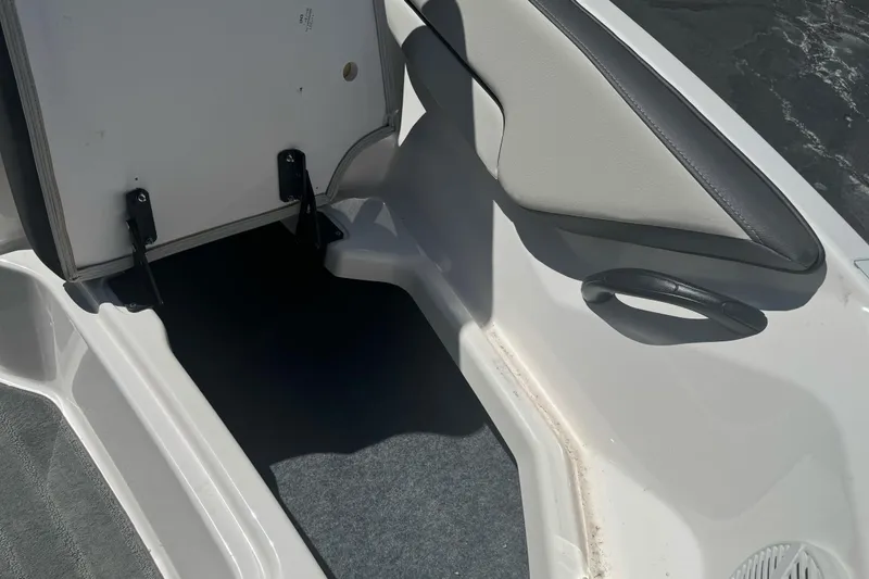 Slide: The Image of 2022 Yamaha Boats AR190 interior storage compartment with open hatch. - 16