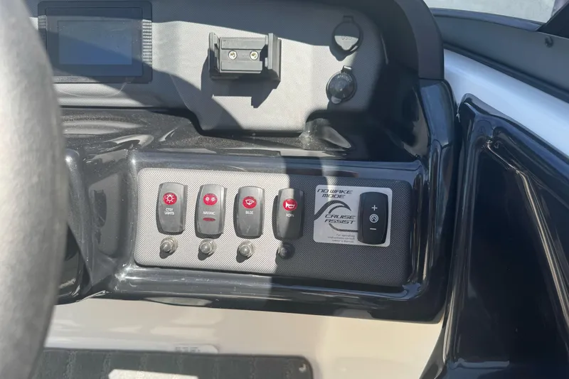 Slide: The Image of Control panel of a 2022 Yamaha Boats AR190, featuring various switches and cruise assist. - 21