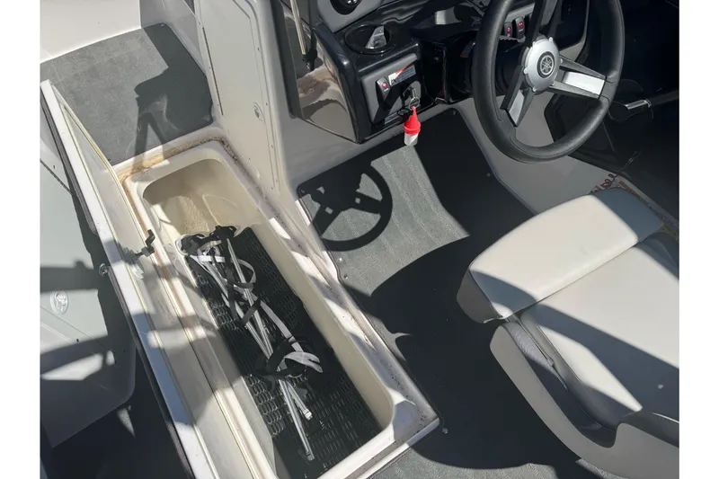 Slide: The Image of 2022 Yamaha Boats AR190 interior with storage compartment and steering wheel. - 23