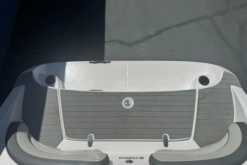Slide: The Image of 2022 Yamaha Boats AR190 swim platform with gray decking and cup holders. - 34