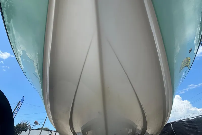 Slide: The Image of 2014 Mako 21 LTS boat hull viewed from below against a clear sky. - 13
